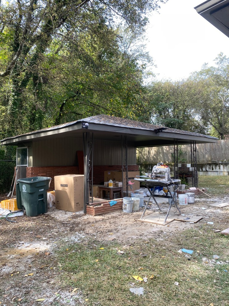 Photo of a separate structure behind a home. Structure could be used for storage shed, carport or more.