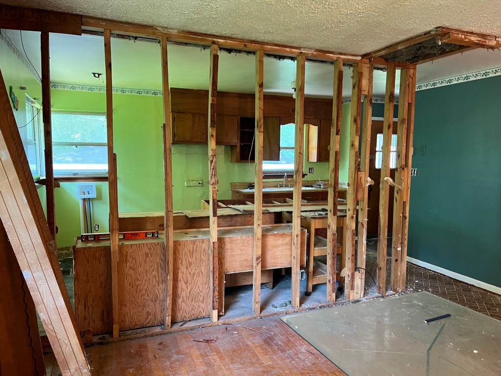 Kitchen renovation. Photo shows exposed beams and wall having just been removed.